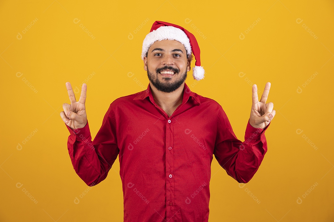 Handsome man dressed for Christmas with Santa hat.