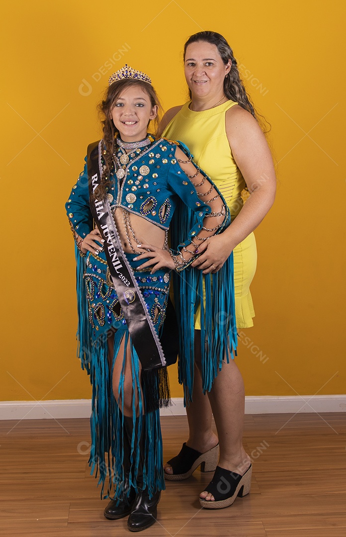 Mãe tirando foto com sua filha usando fantasia de dança do ventre