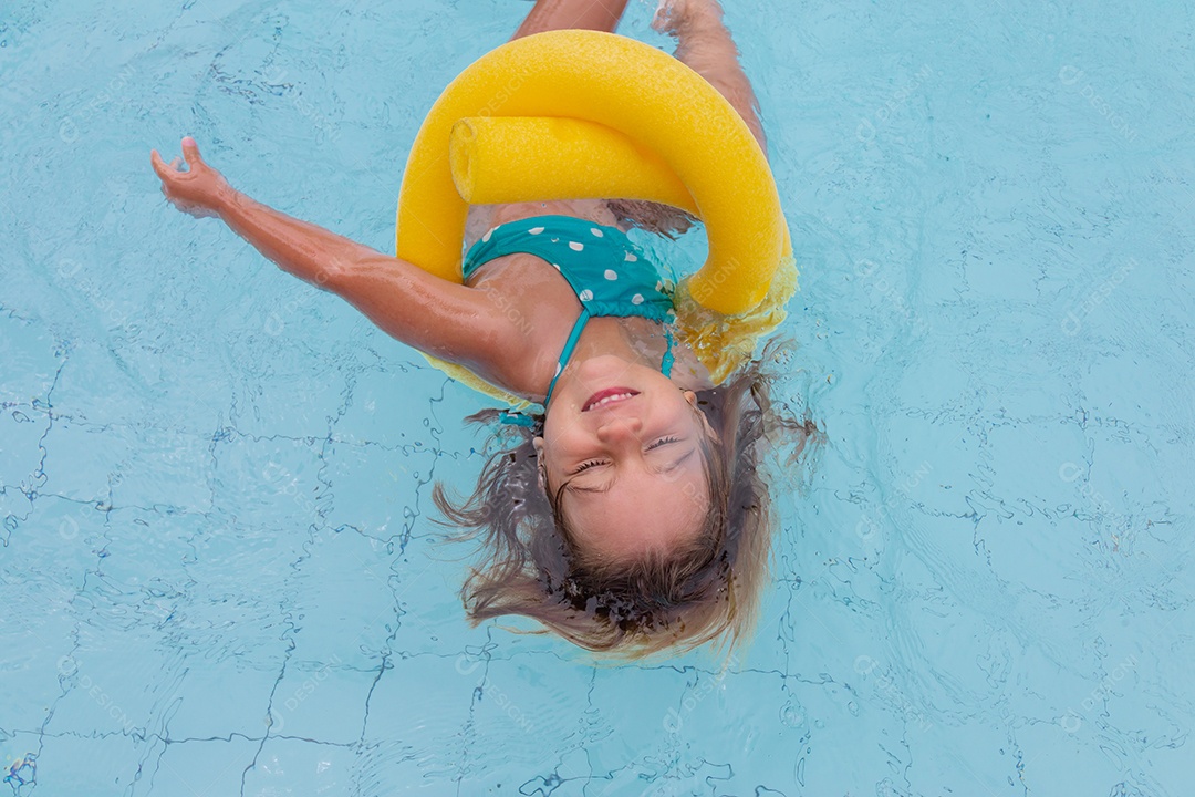 Linda menina garotinha usando biquini sobre piscina curtindo verão