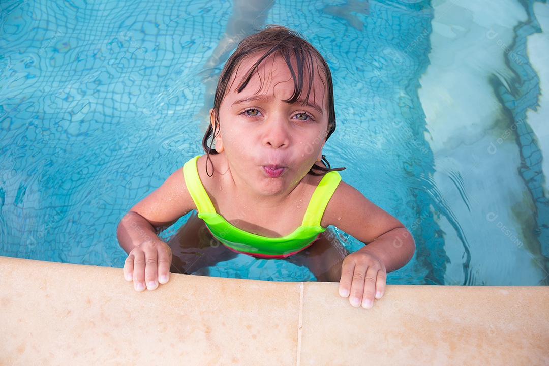 Linda menina garotinha usando roupas de banho sobre piscina curtindo verão