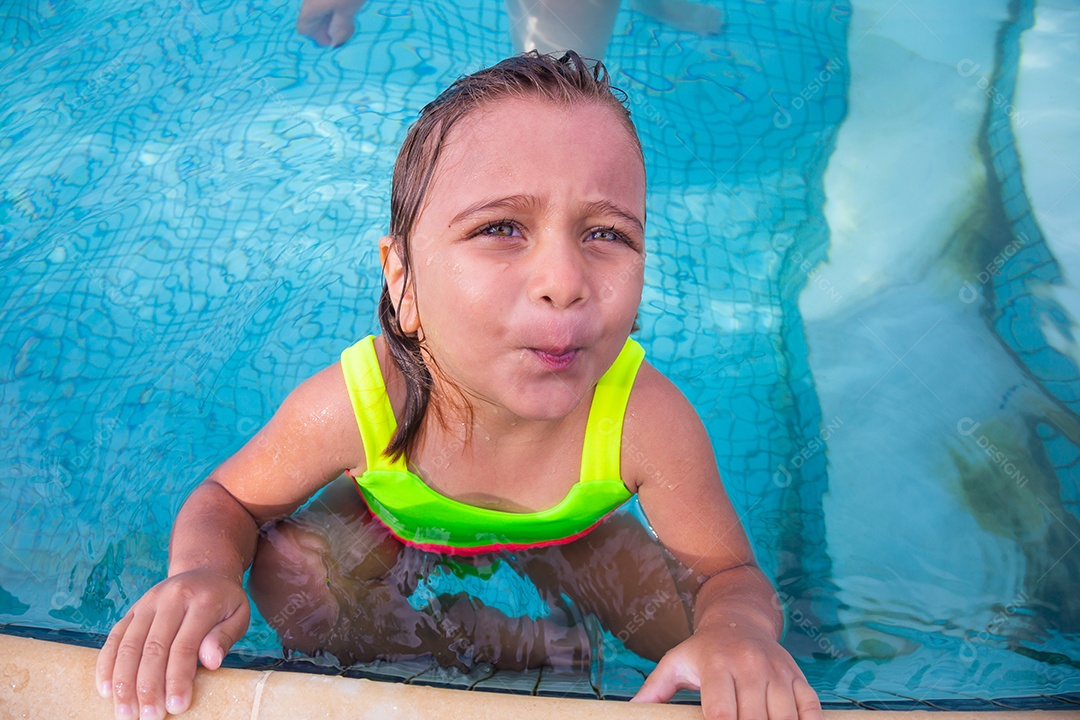 Linda menina garotinha usando roupas de banho sobre piscina curtindo verão