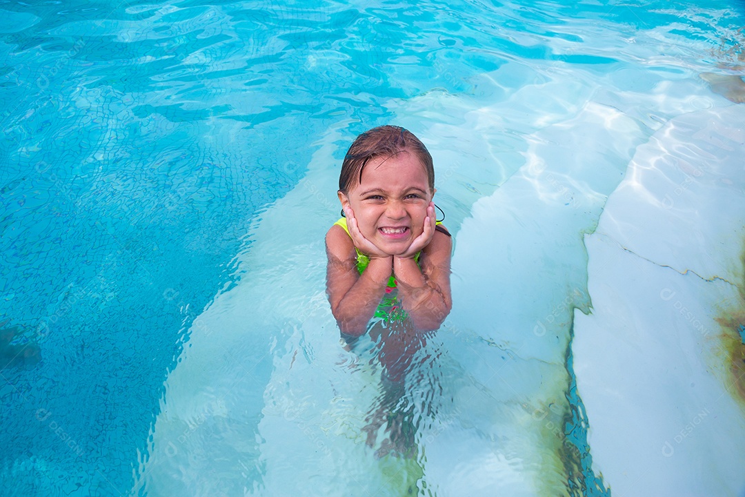 Linda menina garotinha usando roupas de banho sobre piscina curtindo verão