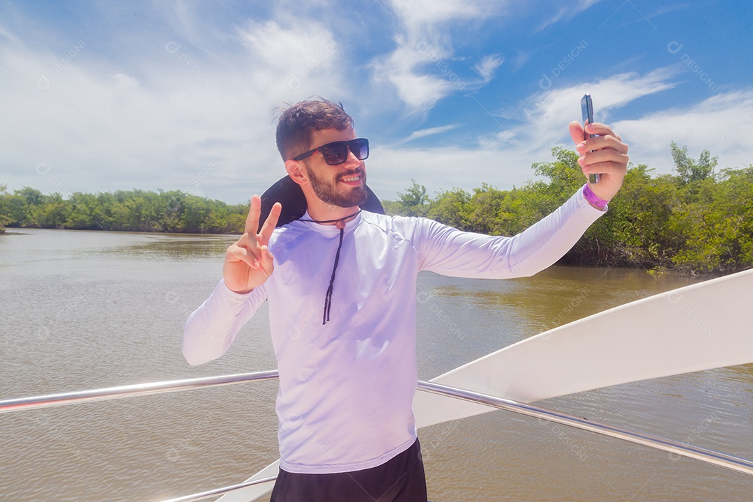 Young man taking selfie enjoying summer vacation