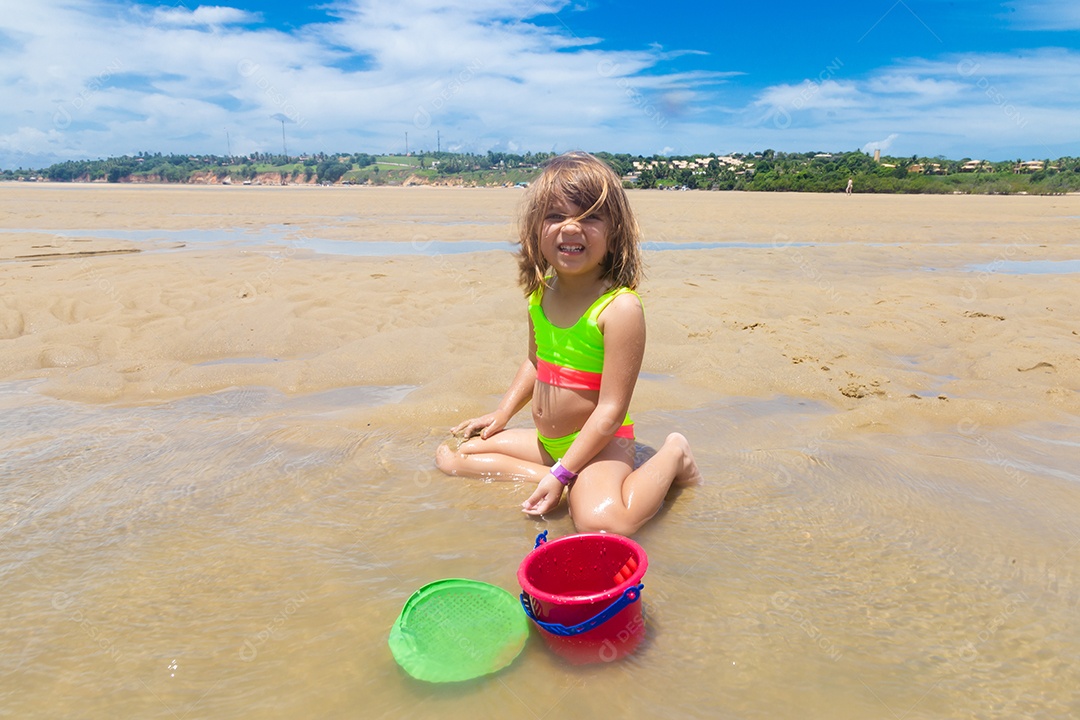 Linda menina garotinha criança sobre praia curtindo verão
