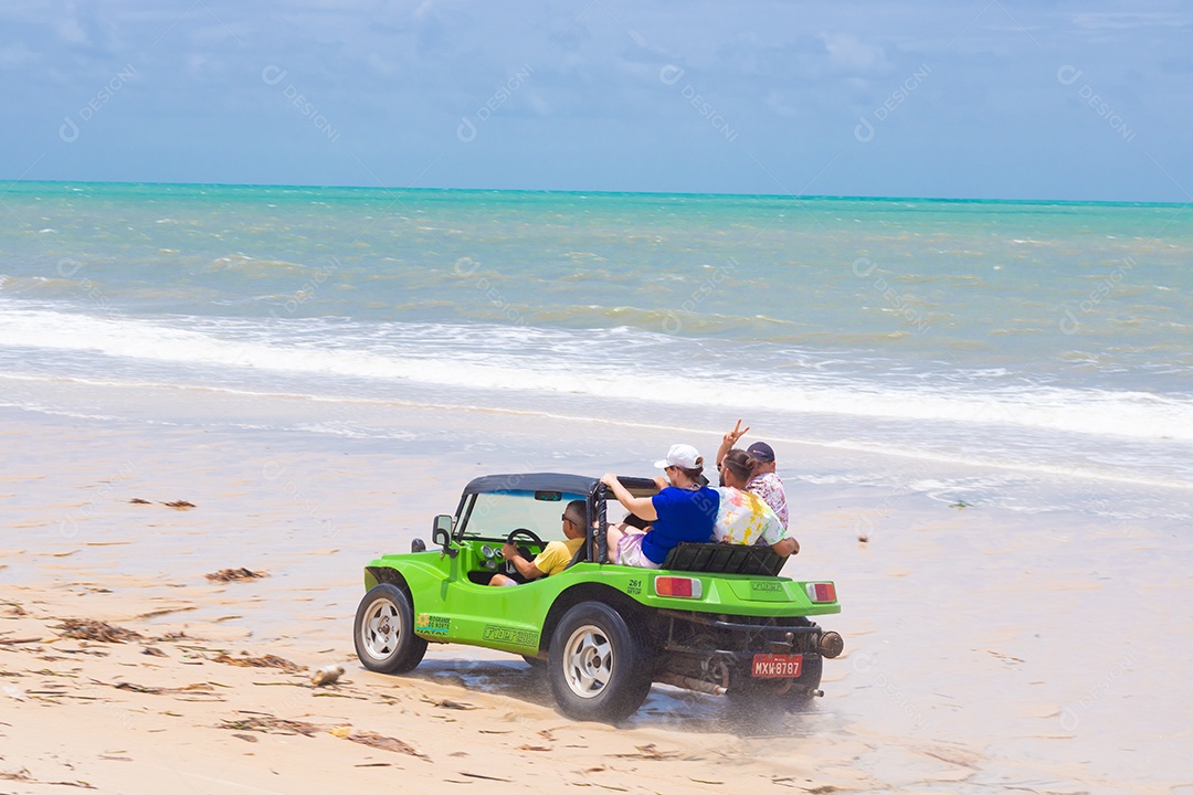 Pessoas jovens andando carro sobre praia verão férias