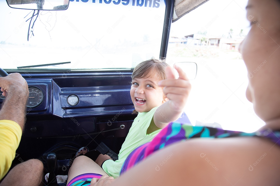 Beautiful child girl happy about vehicle car