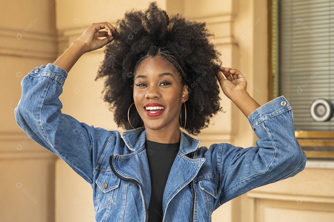 Linda mulher jovem morena cabelo cacheado afro sobre fundo edifício