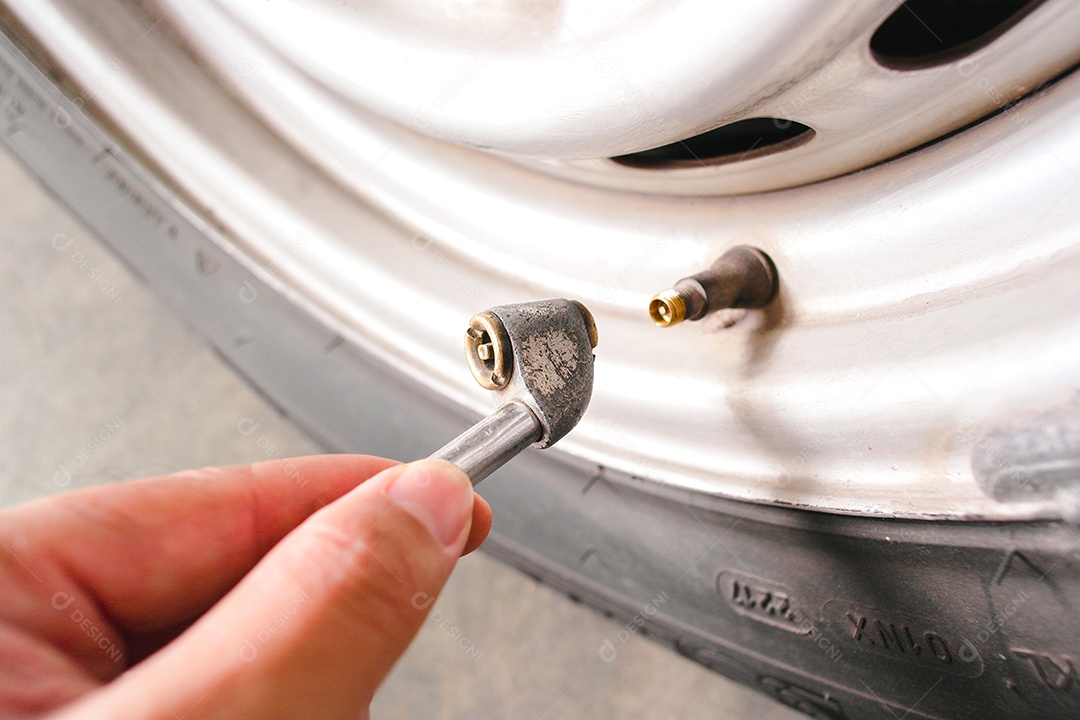 O motorista está inflando um pneu de carro com um mandril de pneu de ar de metal