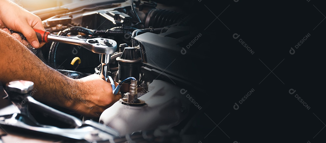 Car mechanic is fixing the car engine with a socket