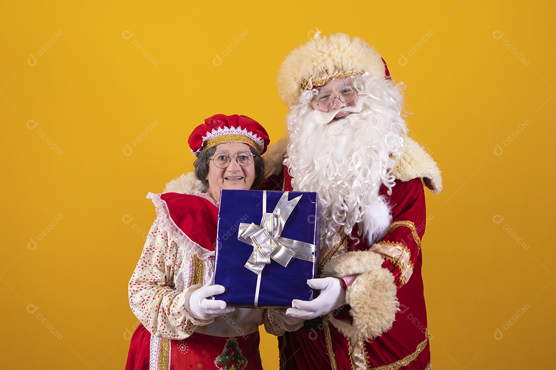 Lindo Casal Papai Noel ao lado de Mamãe Noel sobre fundo isolado amarelo