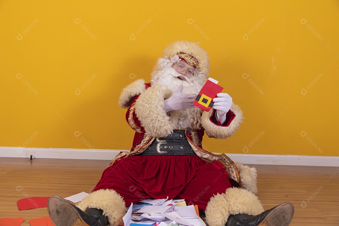Happy Santa Claus holding bills bills yellow background