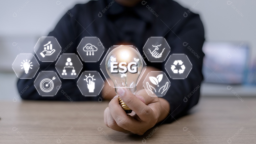 Mão de empresário segurando lâmpada com ícone esg no scr virtual