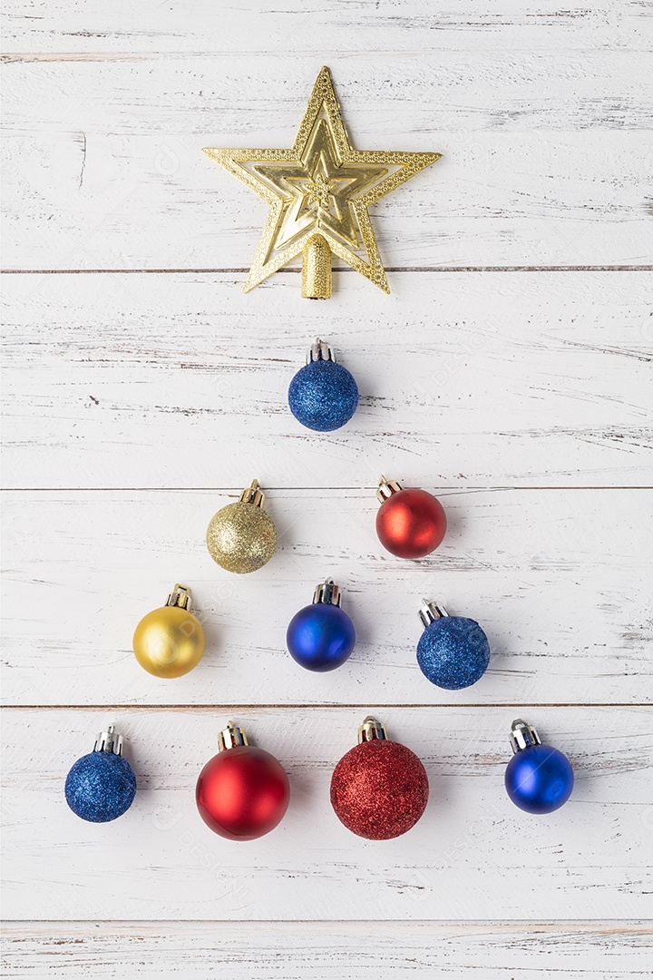 Árvore de natal feita com decoração de natal sobre mesa de madeira.
