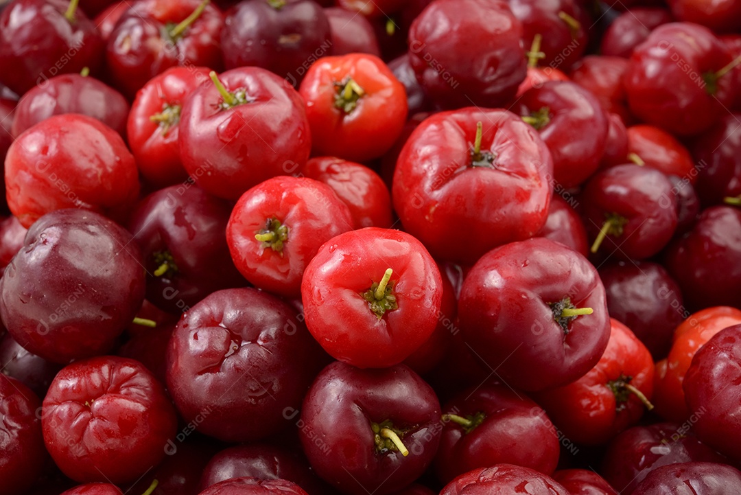 Acerolas de cereja orgânica fresca formando um padrão de fundo.