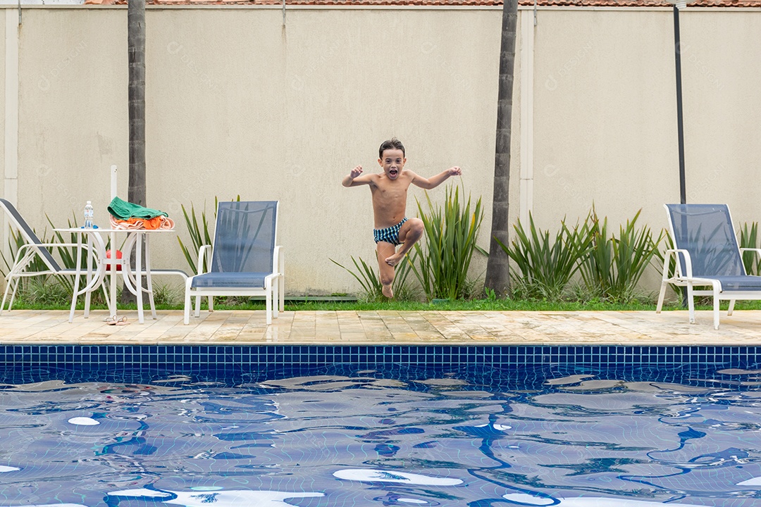 Mulher e filho em sessão de fotos correndo e pulando na piscina.