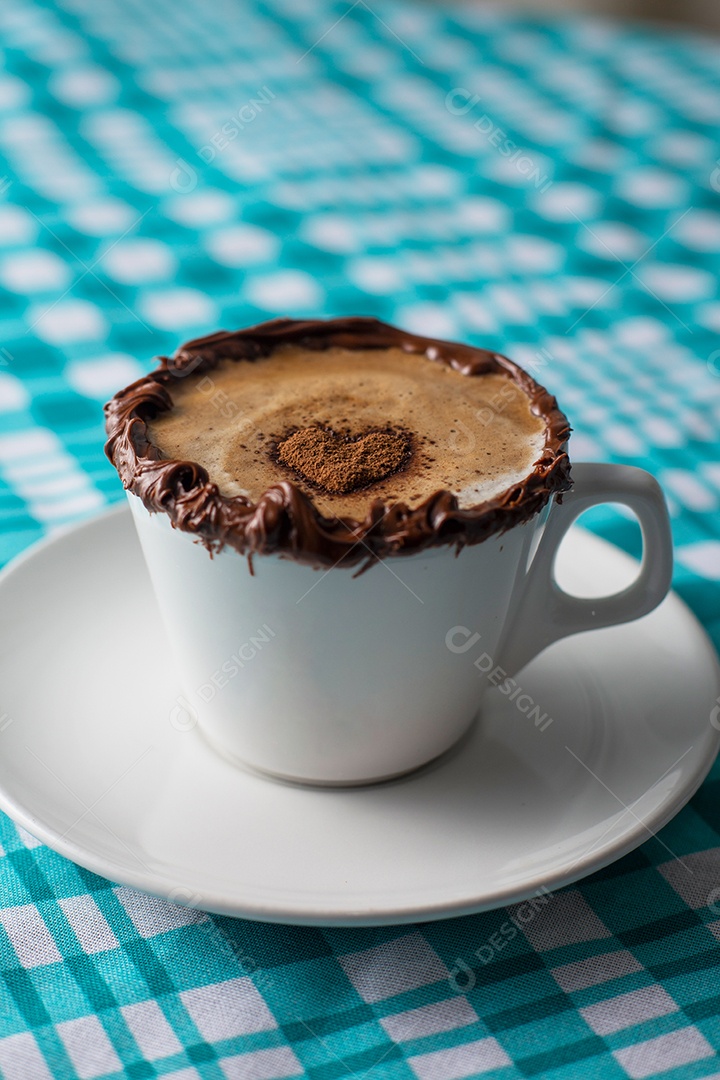 Cappuccino on a white cup at a bakery table