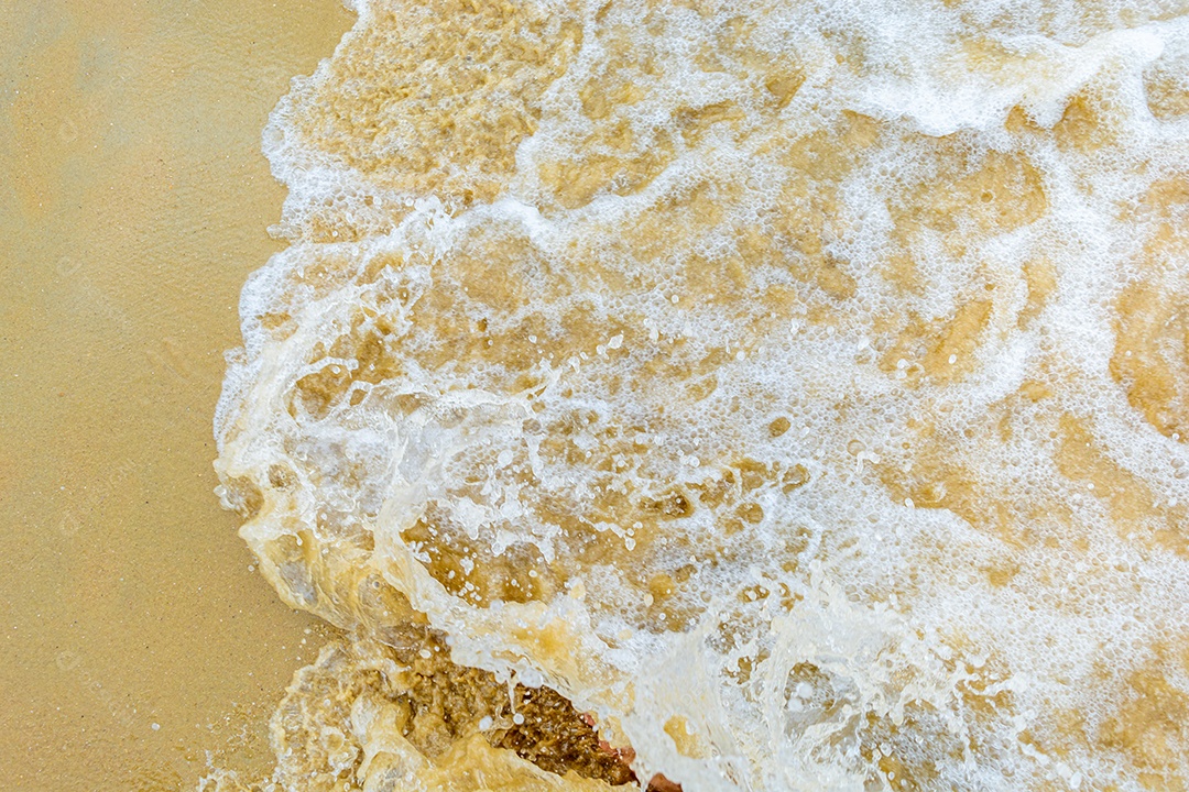 Ondas do mar vindo sobre a areia da praia