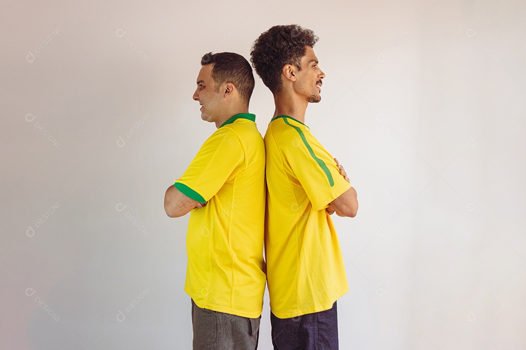 Irmãos negros com camisa amarela brasileira e bandeira torcendo