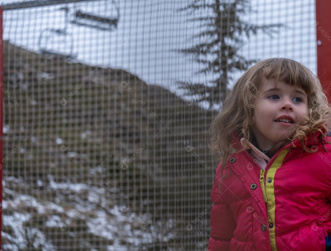 Linda loira brincando na neve na estância de esqui.