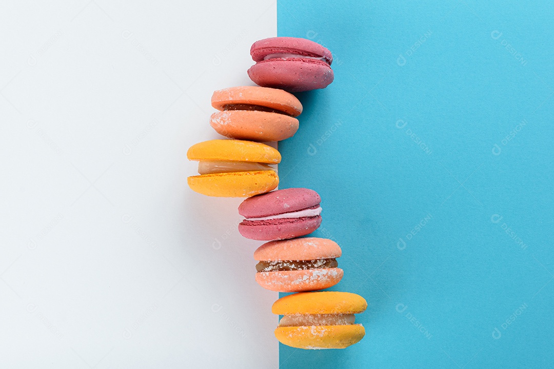 Porção de biscoitos coloridos sobre um fundo branco e azul.
