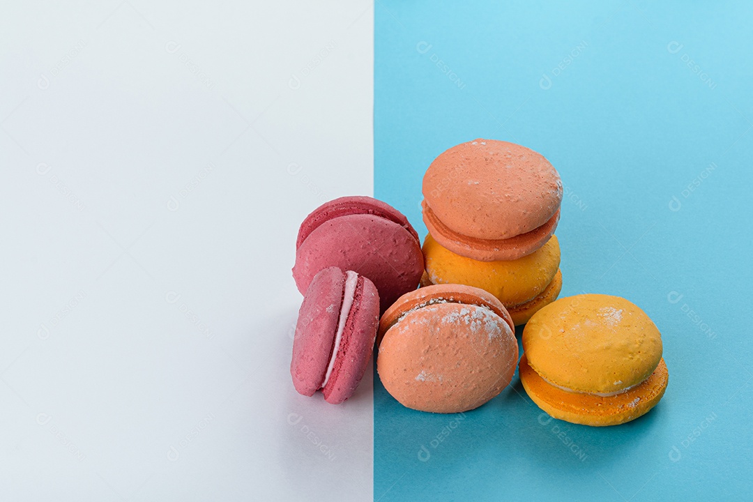 Porção de biscoitos coloridos sobre um fundo branco e azul.