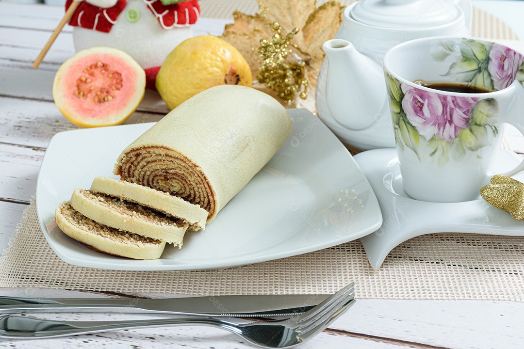 Bolo de rolo ao lado de uma decoração de Natal. Doce tradicional