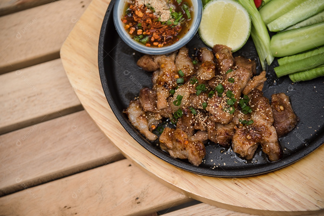 Prato sobre uma mesa de madeira legumes limão carne molho