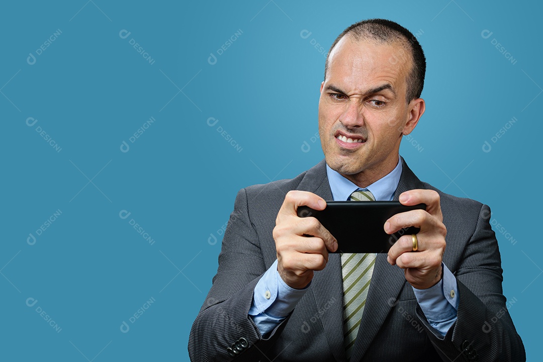 Mature man in suit and tie playing on his smartphone