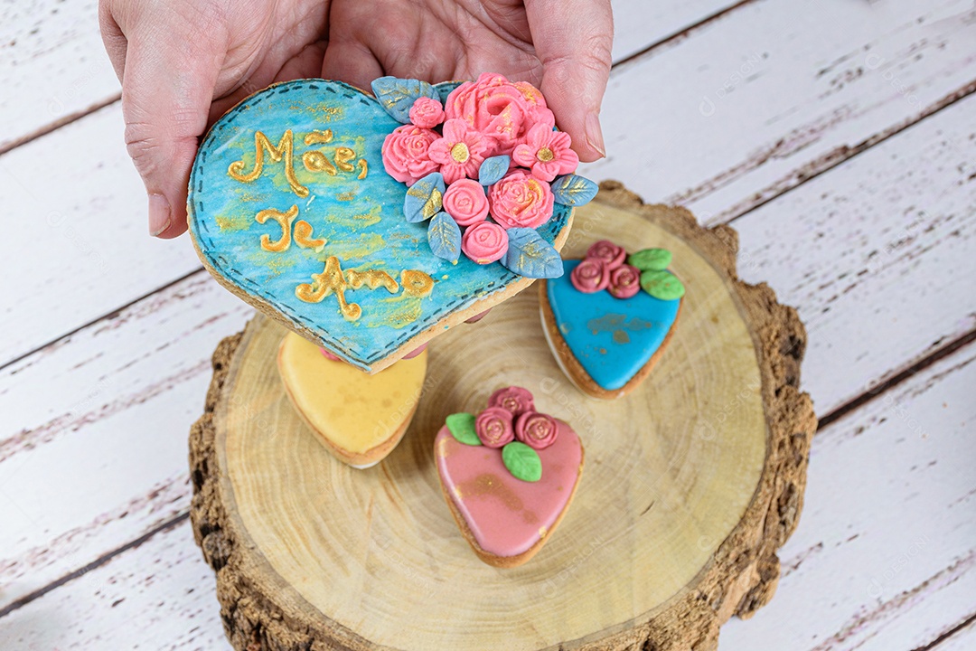 Hand holding a shortbread decorated with rolling fondant