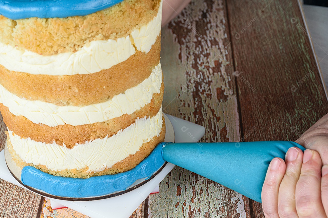 Baker usando um bico de confeiteiro para colocar glacê