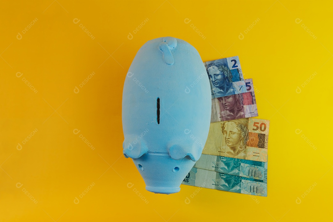Pig with Brazilian coins isolated on yellow background