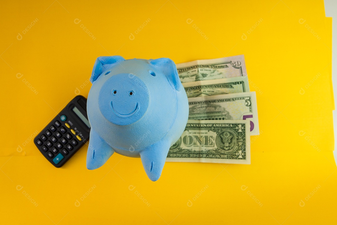 Pig with Brazilian coins isolated on yellow background