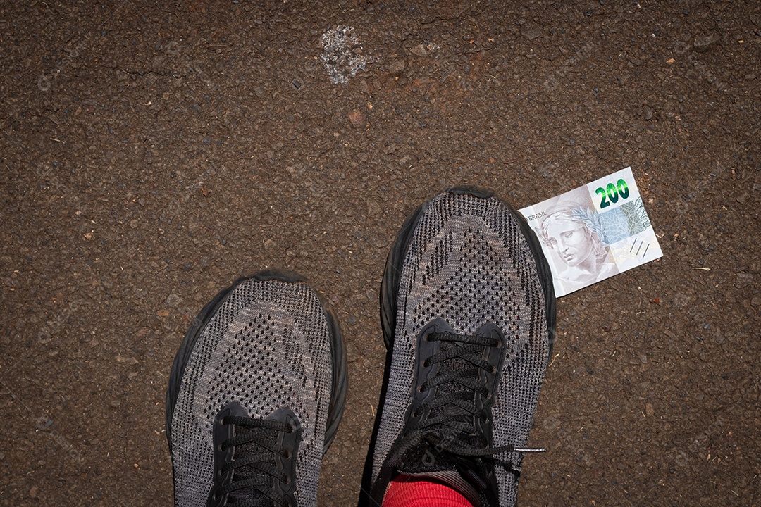 Pisando no dinheiro brasileiro. Imagem do conceito da economia brasileira.