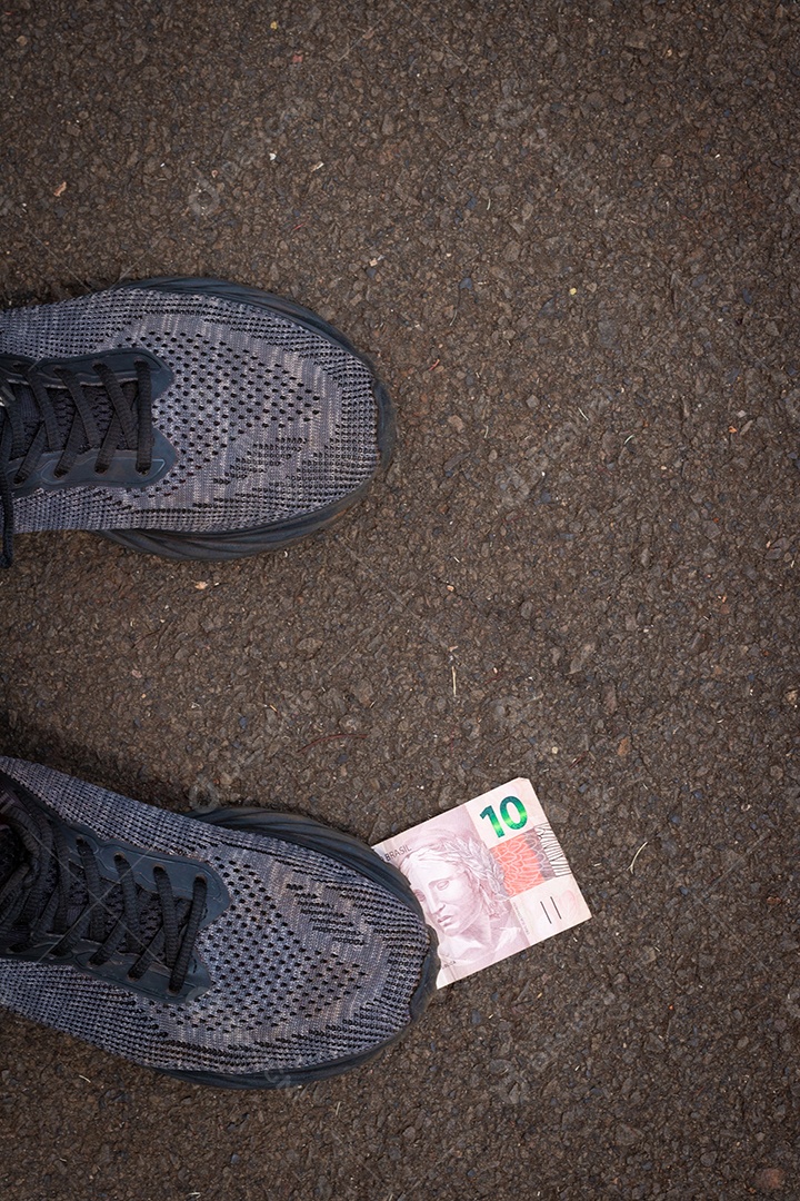 Pisando no dinheiro brasileiro. Imagem do conceito da economia brasileira.