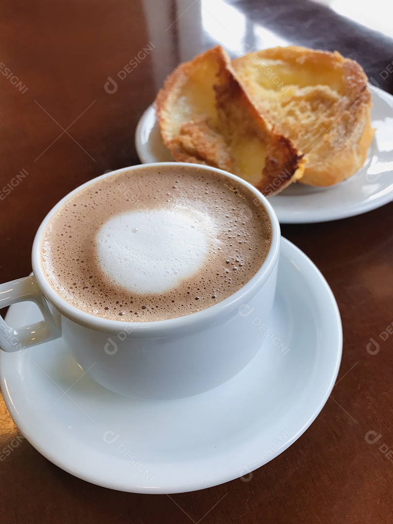 Café da manhã brasileiro. Xícara de capuccino e pão torrado com manteiga