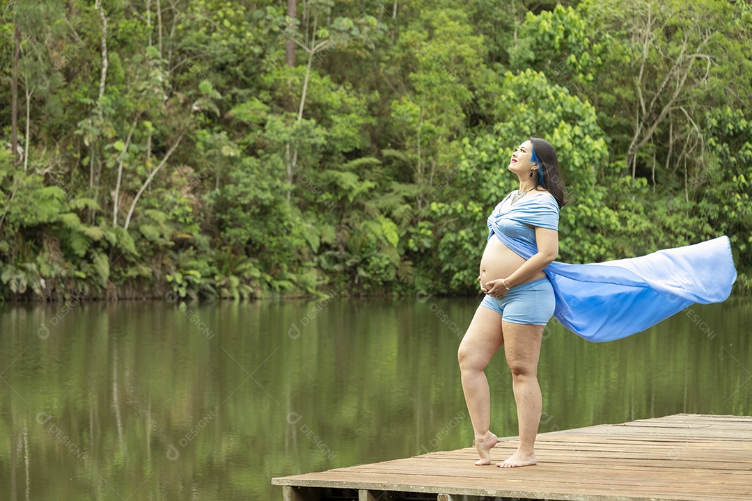 Linda mulher gravida sobre uma linda paisagem