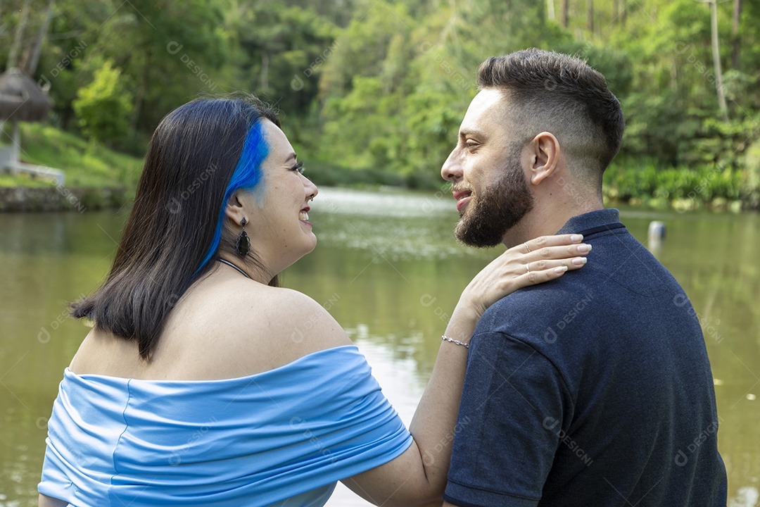 Homem com ao lado de sua esposa gravida sobre um lindo lugar paisagem