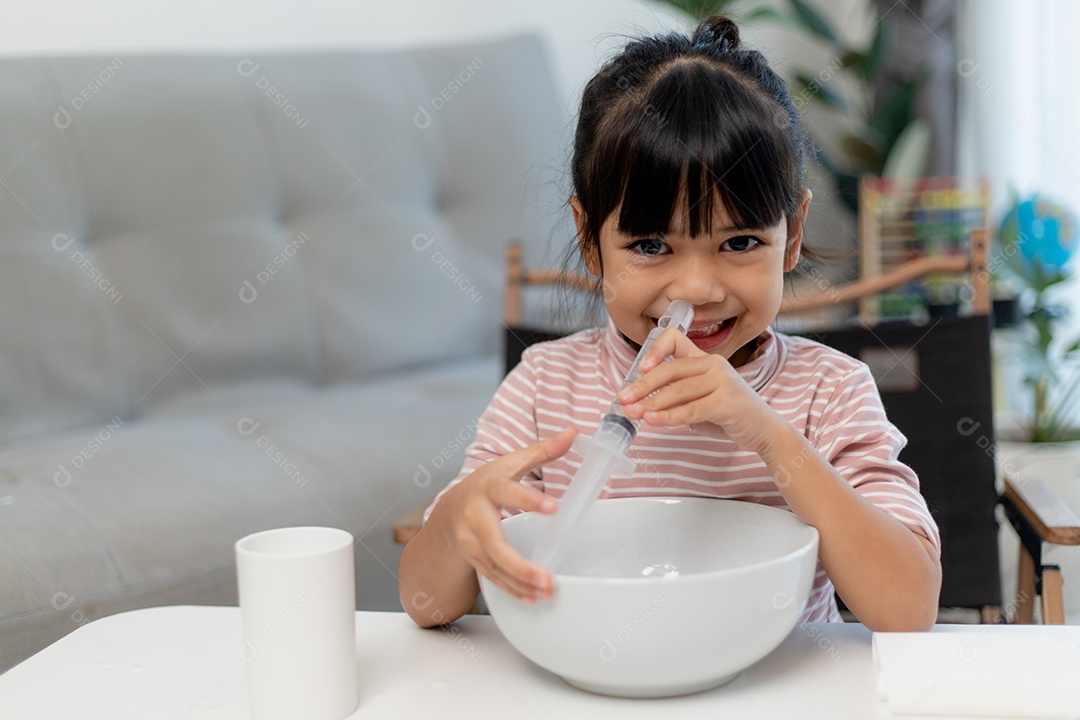 Menina asiática economizando dinheiro em um cofrinho