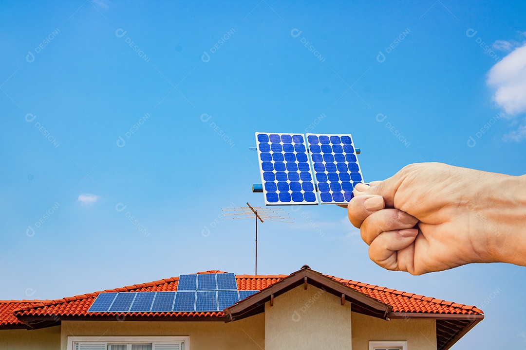 Segurando o painel solar na frente de uma instalação de casa fotovoltaica. Usina de energia solar em dia ensolarado.