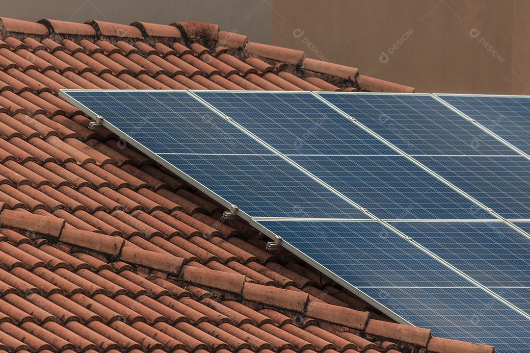 Photovoltaic solar panel on a roof in suset. Solar energy house business concept image.