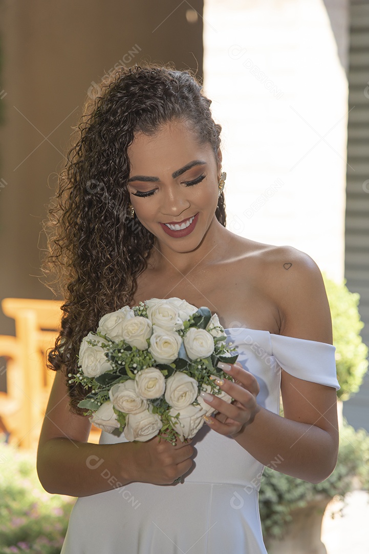 Beautiful bride holding bouquet of flowers on her wedding day