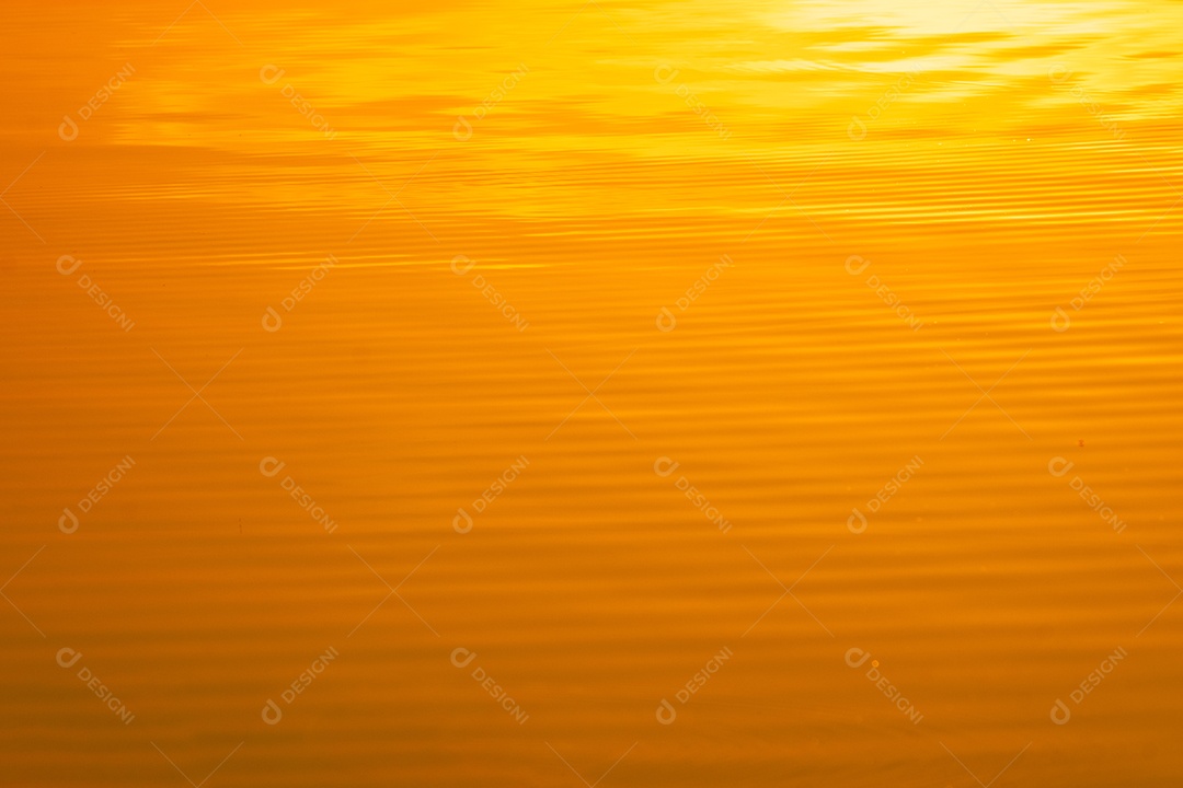 Blurred gold color transparent calm water surface texture