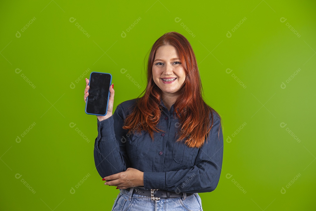 Beautiful young woman girl red hair holding cell phone smartphone
