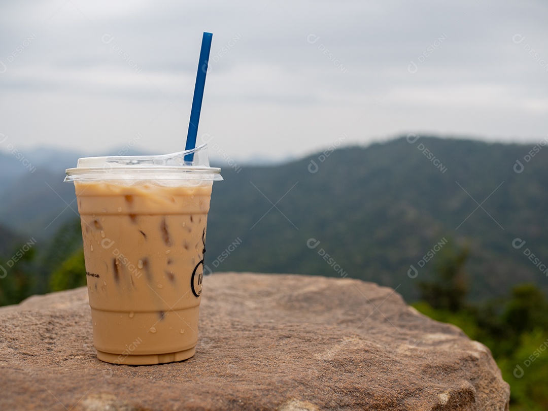 Copo com canudo bebida café gelado com vista de paisagem