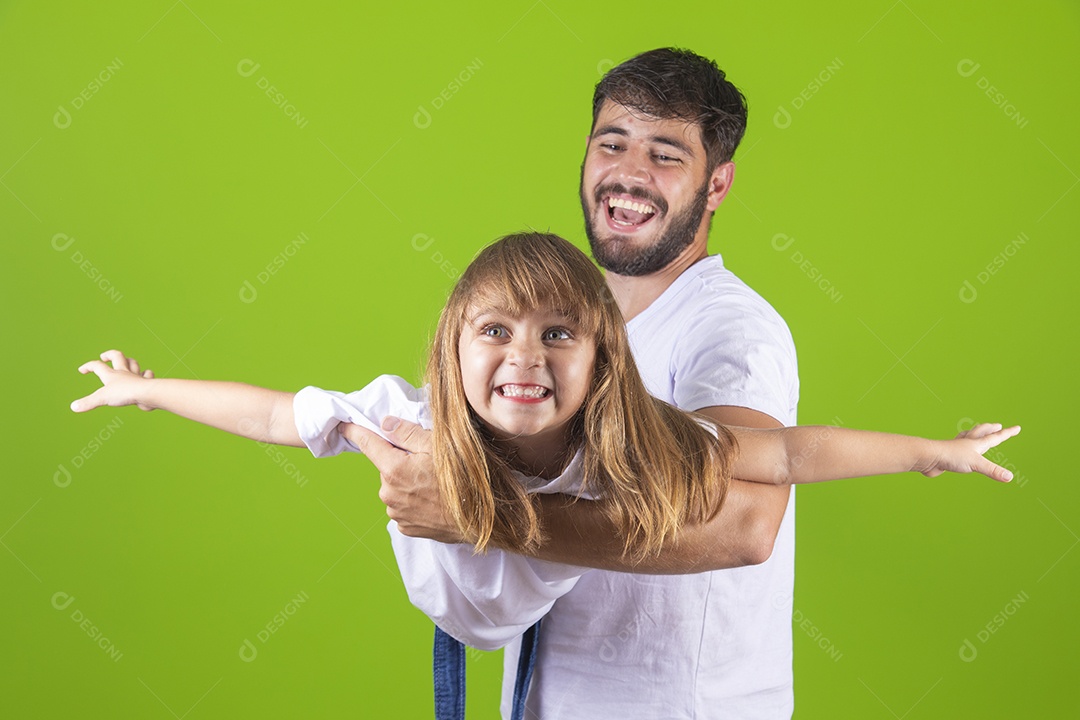 Menina alegre brincando com o pai em sobre fundo isolado amarelo