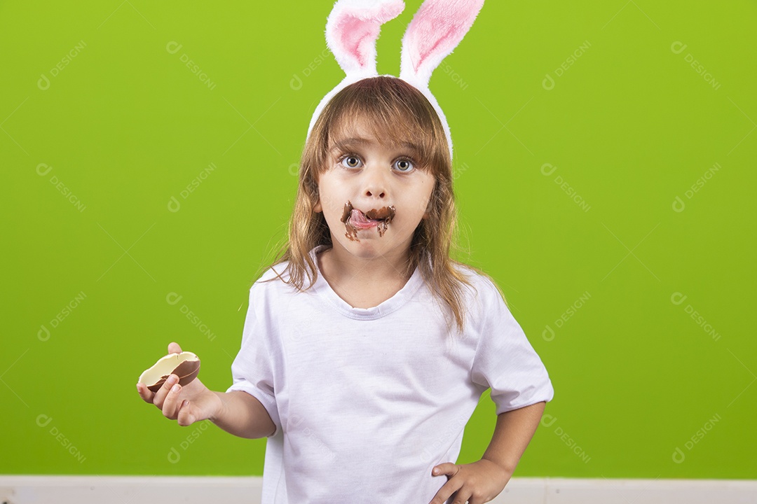 Beautiful little young girl eating cake over isolated background