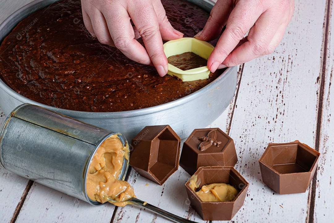 Confeiteiro cortando um pedaço de bolo de mel brasileiro