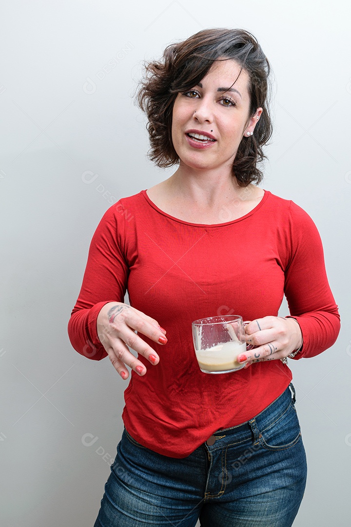 Brazilian woman turning her head while holding a cappuccino mug
