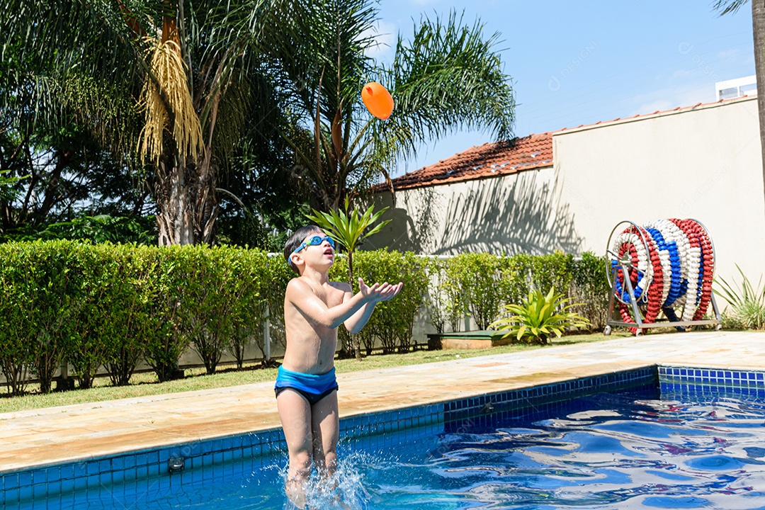 Water pump floating in the air and blurred 8 year old child with diving goggles