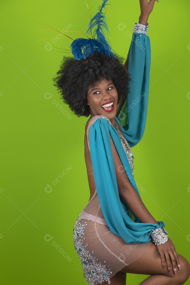 Beautiful young woman wearing carnival costume over isolated background